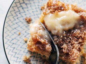 A fork cuts into apple cake.