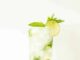vodka mojito in a mojito glass garnished with lime slice and mint sprig