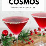 2 boissons cosmopolites vierges avec un bord de citron vert et de sucre sur une planche de bois avec des décorations de Noël