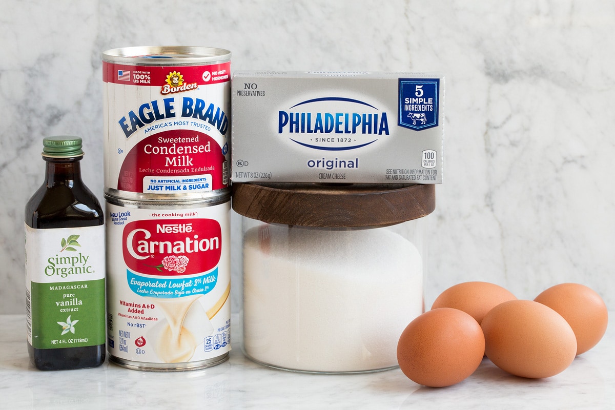 Recette de flans Image des ingrédients utilisés pour faire le flan. Affiche le lait évaporé, le lait concentré sucré, le sucre granulé, la vanille, les œufs et le fromage à la crème.