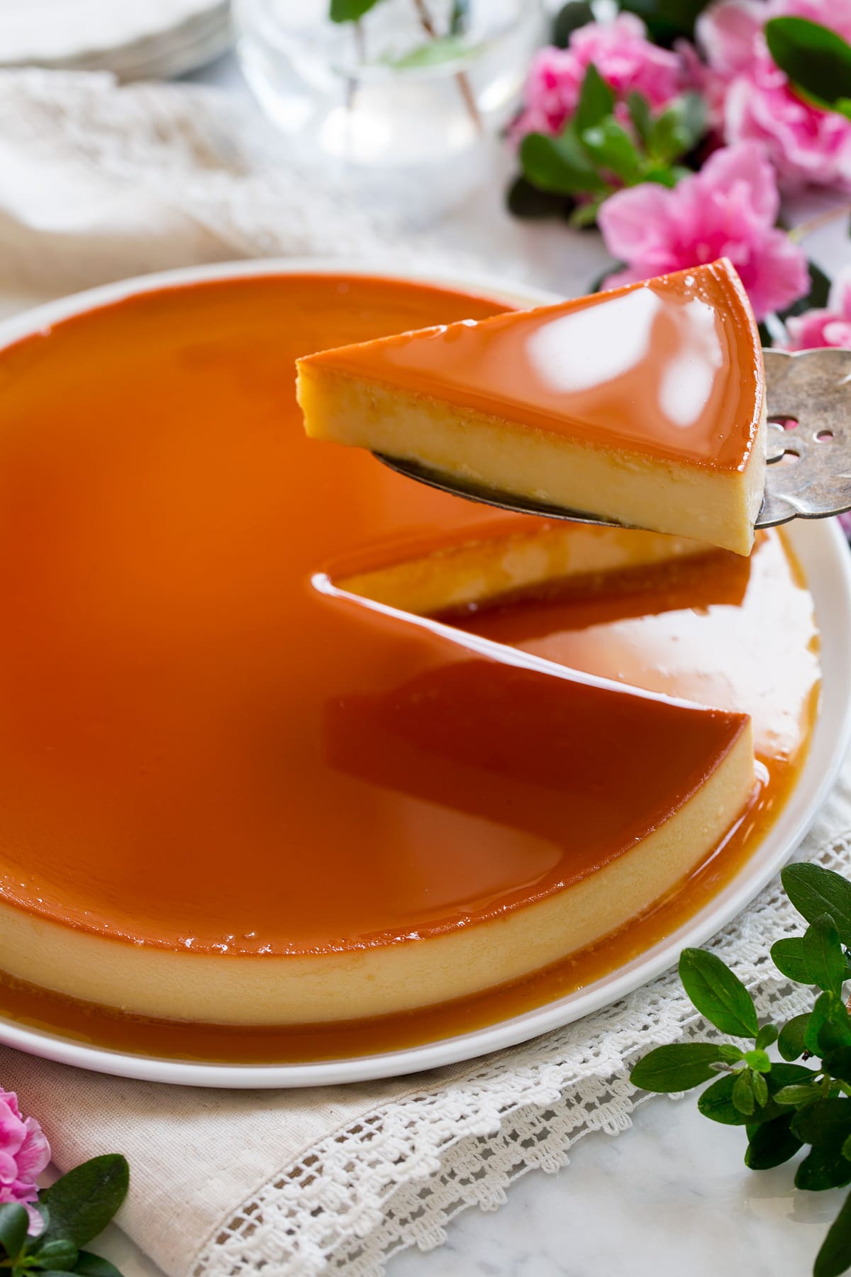 Recette de flans Image montrant une spatule de serveur retirant une tranche d'un flan entier.