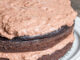 two layer sugar free chocolate cake on a cake stand